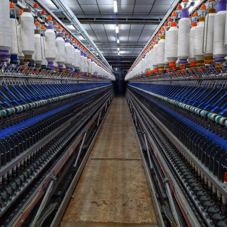 Textile mill with rows of yarn bobbins